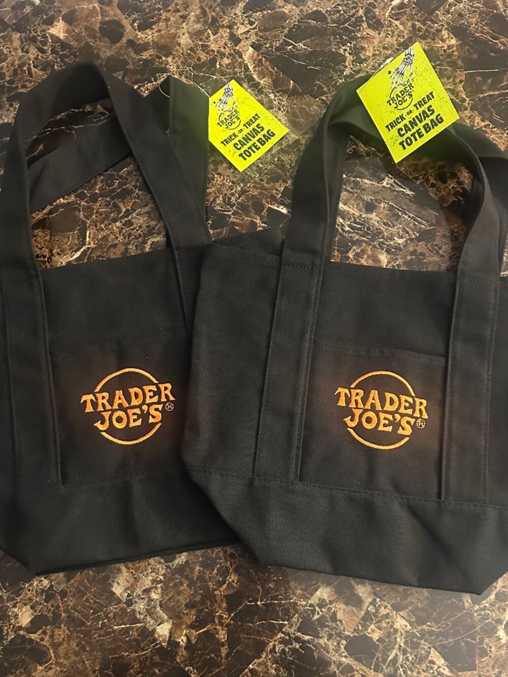 Trader Joe's black Halloween canvas mini totes with orange embroidered logos.